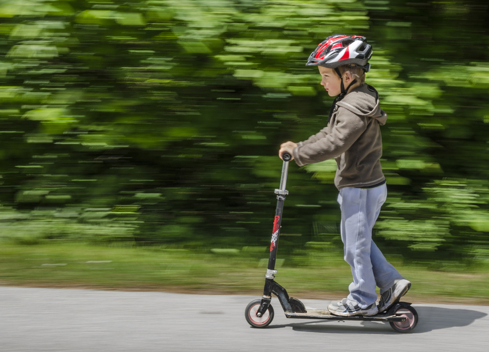 child on scooter with helmet.jpg